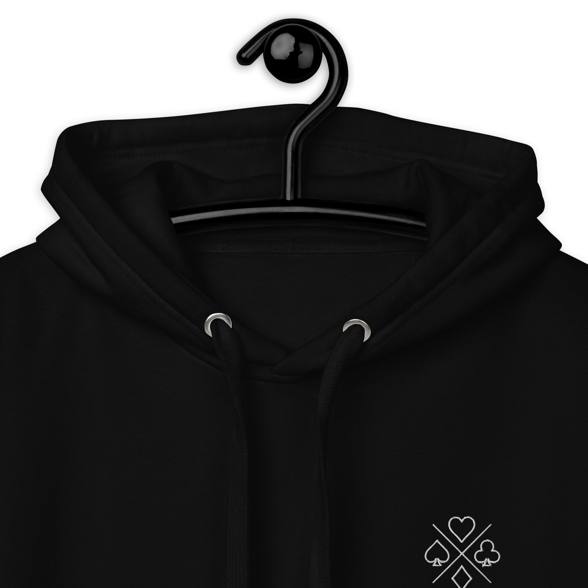Close-up view of the poker suit emblem on a black premium unisex hoodie, emphasizing the intricate embroidery.