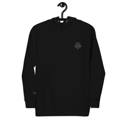 Front view of black premium unisex hoodie on a hanger, showcasing a poker suit emblem design